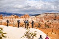 BRYCE CANYON, UTAH, USA - APRIL 2016: Group of hikers admiring a view of red sandstone hoodoos in Bryce Canyon National Park, USA