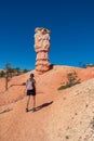 Bryce Canyon - Woman with backpack on Fairyland hiking trail with scenic view on massive hoodoo in Utah, USA Royalty Free Stock Photo