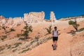 Bryce Canyon - Woman with backpack on Fairyland hiking trail with scenic view on massive hoodoo in Utah, USA Royalty Free Stock Photo