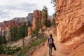 Bryce Canyon - Woman hiking on Queens Garden trail with scenic view of hoodoo sandstone rock formations in Utah, USA Royalty Free Stock Photo