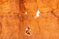 Bryce Canyon - Woman making a peek a boo face through pinnacle rock looking like a face, Bryce Canyon National Park, Utah,