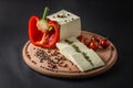 Brynza on Wood Board with Tomatoes, Chilli, Olives, Pepper and Green Spices Royalty Free Stock Photo