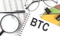 BTC - the inscription of text on the Notepad, and chart. Business concept Royalty Free Stock Photo