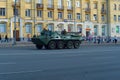 The BTR-80 with paratroopers against the background of strolling citizens