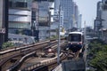 BTS Sky Train is running in downtown pass through skycrapers business building in Bangkok