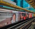BTS Skytrain with commercials on it in the Bangkok city center metro station Royalty Free Stock Photo