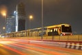 BTS train station and traffic night light car motion on highway in BANGKOK THAILAND