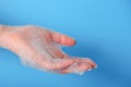 Closeup woman's hand washing with soap on a blue background , selective focus. Practice good Royalty Free Stock Photo