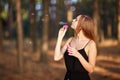 Portrait of pretty woman with bubbles, traveler relaxing in forest.