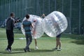 Bubble football. Journalist and cameraman interviewing a man standing in bubble Royalty Free Stock Photo