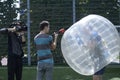 Bubble football. Journalist and cameraman interviewing a man standing in bubble