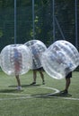 Bubble football. People in bubble inside putting heads together before a game