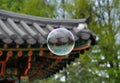 Bubble in front of roof of oriental arbor