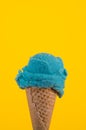 Bubble gum ice cream in a traditional cone on a yellow background