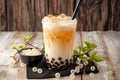 Bubble milk tea displayed on wooden background, enticing beverage concept Royalty Free Stock Photo