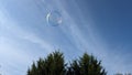 A bubble reflecting light floating high in a blue sky Royalty Free Stock Photo