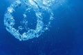 Bubble ring Underwater ascends towards the sun Royalty Free Stock Photo
