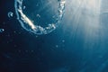 Bubble ring Underwater ascends towards the sun. Royalty Free Stock Photo