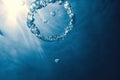Bubble ring Underwater ascends towards the sun. Royalty Free Stock Photo