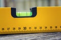 Bubble spirit water level construction tool on wooden board closeup Royalty Free Stock Photo