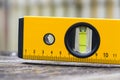 Bubble spirit water level construction tool on wooden board closeup Royalty Free Stock Photo