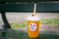 A bubble tea cup on a bench