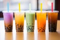 Bubble tea in various settings, variety of tapioca tea milkshake in a row.