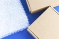 Bubble wrap and cardboard boxes. Transparent plastic material for packing fragile items. Safe delivery, online shopping.