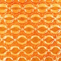 Bubble wrap in front of orange paper.