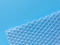 Bubble wrap packing or air cushion film on blue background. Closeup, copy space Royalty Free Stock Photo