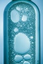 Bubbles of blue liquid in various shapes