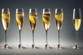 Bubbles of champagne bubbling in glasses on thin glass stems. Royalty Free Stock Photo