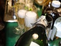 Bubbles coming off poured champagne in a foamy glass with surrounding bottle shapes and more champagne being poured Royalty Free Stock Photo