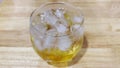 The bubbles created by mixing liquor and soda in a clear glass waft on the table, ready to refresh