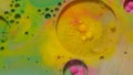 Bubbles float in liquid paint, mixing ink, oil and milk, abstract multicolor hypnotic painting Royalty Free Stock Photo