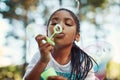 Bubbles are her fairy dust. a little girl dressed up as a fairy and playing with bubbles in the woods. Royalty Free Stock Photo