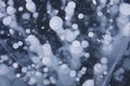 Bubbles in ice of Baikal lake. Winter texture Royalty Free Stock Photo