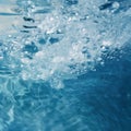 Bubbles in a pool of water, with blue and white waves gently rippling in the background Royalty Free Stock Photo