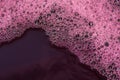 Bubbles of red wine closeup. Alcoholic background Royalty Free Stock Photo
