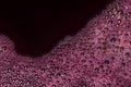 Bubbles of red wine closeup. Alcoholic background Royalty Free Stock Photo