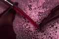 Bubbles of red wine closeup. Alcoholic background Royalty Free Stock Photo