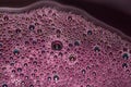Bubbles of red wine closeup. Alcoholic background Royalty Free Stock Photo