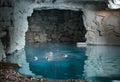 Bubbles rising slowly from an underground thermal spring in a stone cave Royalty Free Stock Photo