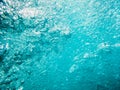 Bubbles in tropical sea. Underwater turquoise texture in ocean Royalty Free Stock Photo