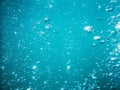 Bubbles in tropical sea. Underwater turquoise texture in ocean Royalty Free Stock Photo