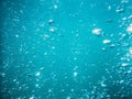 Bubbles in tropical sea. Underwater turquoise texture in ocean Royalty Free Stock Photo