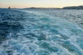 Bubbling blue waves of traces of tourist cruise ships passing on the Bosporus. Water trail foaming behind a passenger