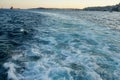 Bubbling blue waves of traces of tourist cruise ships passing on the Bosporus. Water trail foaming behind a passenger