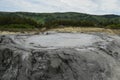 Bubbling crater of a mud volcano. Close up view onto gas bubble exploding in crater of mud volcano. Mud volcano at Paclele Mari, Royalty Free Stock Photo