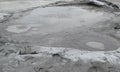 Bubbling crater of a mud volcano. Close up view onto gas bubble exploding in crater of mud volcano. Mud volcano at Paclele Mari, Royalty Free Stock Photo